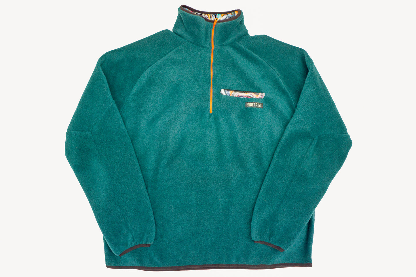 A petrol blue fleece with an orange coloured half zip opening with multi-colour oil slick contrast details on collar and pocket  with black binding to hem and cuffs